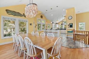 a dining room with a wooden table and chairs at Animal House in Corolla