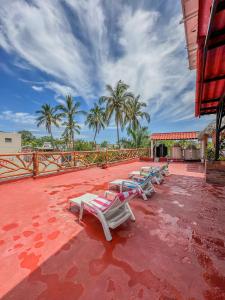 a group of lounge chairs sitting on a patio at La Casa Mariposa in Rincon de Guayabitos +23 photos
