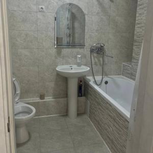 a bathroom with a sink and a toilet and a tub at A cozy and bright studio apartment in Chornomorsk +7 photos