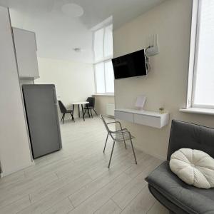 a living room with a couch and a table at A cozy and bright studio apartment in Chornomorsk