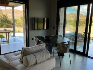 a living room with a couch and a table and chairs at Petras Estate in Skala Eresou