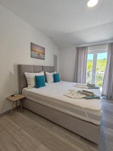 Postel nebo postele na pokoji v ubytování Apartments Kata