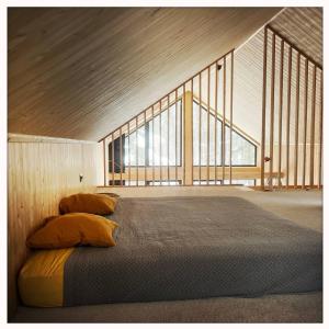 a large bed in a room with large windows at Vilka in Holendry