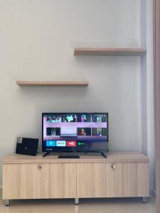 a flat screen tv sitting on top of a wooden entertainment center at Sunrise Sea & Mountain Vista Apartments in Orikum