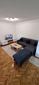 a living room with a couch and a coffee table at Apartman OZ II in Bihać