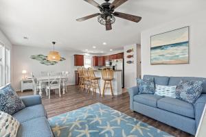 a living room with a couch and a dining room at Aqua Adventure in Kill Devil Hills +30 photos