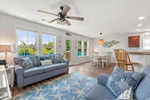 a living room with a couch and a table at Aqua Adventure in Kill Devil Hills