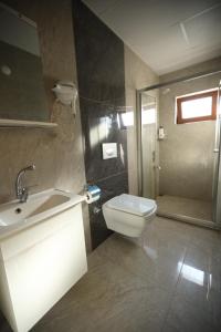 a bathroom with a toilet and a sink and a shower at Amasra Emek PANSİYON in Amasra +29 photos