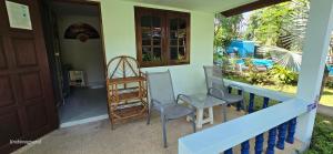 a house with a porch with chairs and a door at Sabai Resort in Ao Nang Beach