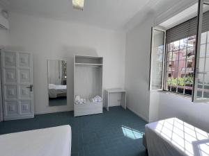 a white room with a bed and a mirror at Green Park San Pancrazio in Rome