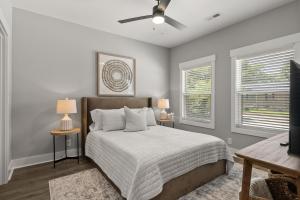 a bedroom with a bed and two windows at Rivers Edge - 111 Hickory Grove BLVD in Clarksville