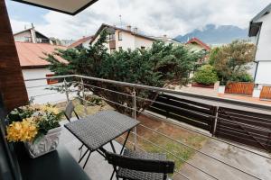a balcony with a table and chairs on a balcony at INLE Homestay in Nová Lesná