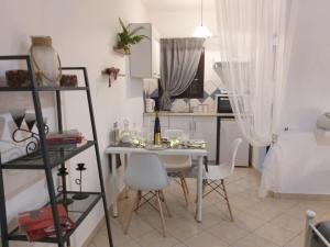 a small dining room with a table and chairs at Adelia's Luxury Studio in Corfu in Corfu