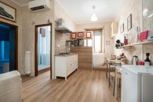 a kitchen with a counter and a table in it at Bettí House vasca idromassaggio metro C Alessandrino - San Giovanni e trenino laziali-Termini -Bettí House in Rome