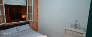 a small bedroom with a bed and a window at Relax y bienestar in Valencia