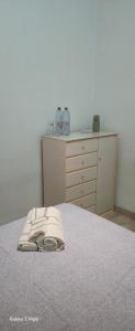 a bedroom with a bed and a dresser with a telephone at Relax y bienestar in Valencia
