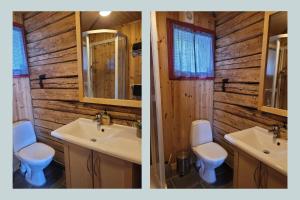 two sinks and a toilet in a wooden bathroom at Reine Harbour Cabins in Moskenes +33 photos