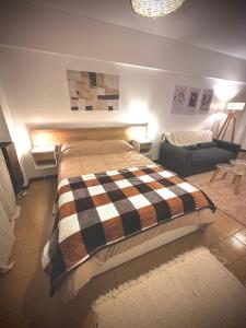 a bedroom with a large bed and a couch at Marcelinos la perla in Mar del Plata