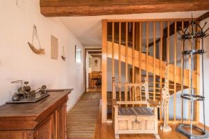a kitchen with a wooden staircase and a wooden chair at Ferienwohnung Achraintal 1 in Lindau +17 photos