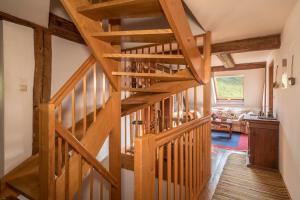 a wooden staircase in a house with a living room at Ferienwohnung Achraintal 1 in Lindau