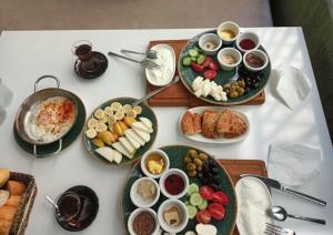 a white table with plates of food on it at Siya Boutique Hotel in Batman