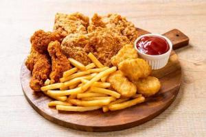 a plate of fried chicken and french fries with ketchup at Stj Luxury Hotels in Ilorin +10 photos