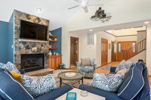 a living room with a blue couch and a fireplace at Blue Oasis in Duck