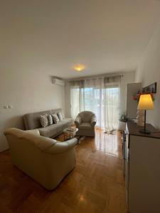 a living room with a couch and a chair at Apartment Sara in Solin