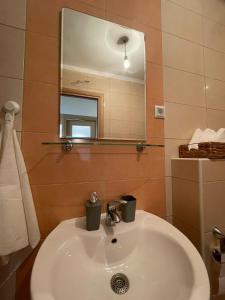 a bathroom with a white sink and a mirror at Apartment Sara in Solin +23 photos