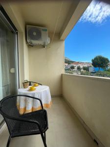 a table and a chair in a room with a window at Apartment Sara in Solin