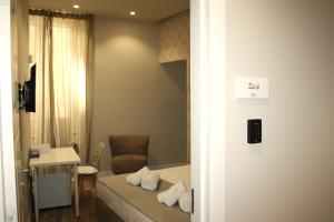 a hotel room with a bed and a chair and a desk at Palazzo Partenope in San Severo