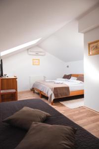 a bedroom with two beds in a room at Garni Hotel Keltika in Izola