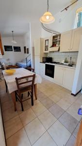 a kitchen with a table and chairs and a table and a kitchen at Marianna Home and Parking in Monterosso al Mare