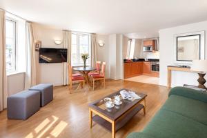 a living room with a couch and a table at Marlin Apartments London City - Queen Street in London