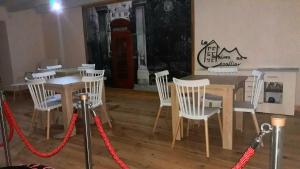 a room with a table and chairs and a red rope at La Maison en Cézallier - Roses in Marcenat