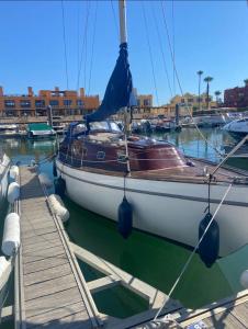 a sailboat docked at a dock in a harbor at Bily Boat Praia da Rocha Portimão in Portimão