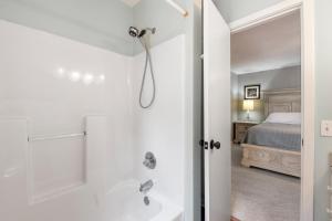 a bathroom with a shower and a bed at Blue Paradise Club in Kitty Hawk +16 photos