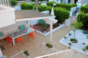 an aerial view of a patio with a table and chairs at EcoLiving Casa Vacanze in Torre Lapillo