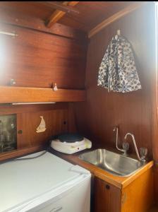 a small kitchen with a sink and a stove at Bily Boat Praia da Rocha Portimão in Portimão