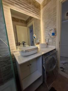 a bathroom with a sink and a mirror at Modern City Apartment in Cairo