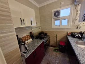 a kitchen with a sink and a counter top at Modern City Apartment in Cairo +6 photos