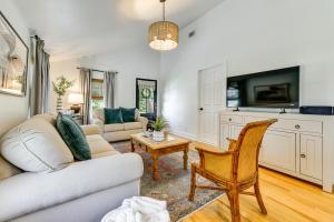 a living room with a couch and a table at Home 2 Mi to Beach and Old Town Bay St Louis! in Bay Saint Louis