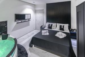 a hotel room with a bed and a bath tub at Amour - House with Private Jacuzzi in Rosolini