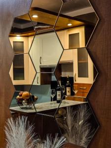 a mirror on the wall of a kitchen with a table at Gunram Mazury in Okowizna