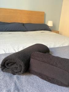 a towel laying on top of a bed at Blue House in Turin