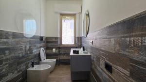 a bathroom with two toilets and a sink at Affittacamere Brezza Di Sirolo in Sirolo +32 photos