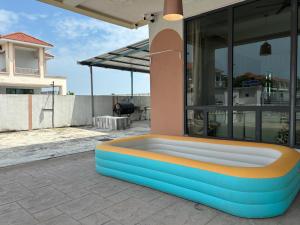 a bench on the side of a house at My Homestay @ Morib Bay Banting in Banting