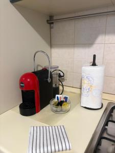 a kitchen counter with a toaster and a bowl of fruit at Blue House in Turin +7 photos