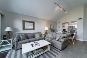 a living room with a couch and a table at 1304 Pelican Watch Villa in Seabrook Island