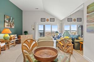 a living room with a table and chairs at 1340 Pelican Watch Villa in Seabrook Island